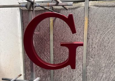 custom fabricated aluminum monogram for driveway gate